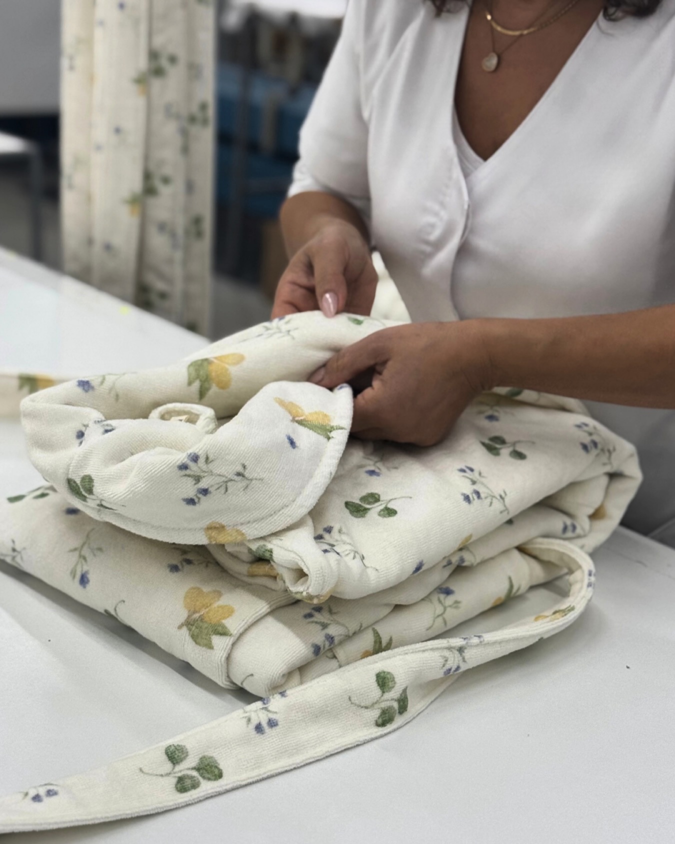 A manufacturer doing a robe in a factory.