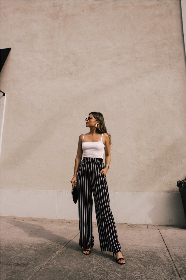 Ideas To Dress In Wide-Leg Trousers for the summer. Black and white stripes pants with a white tank top.