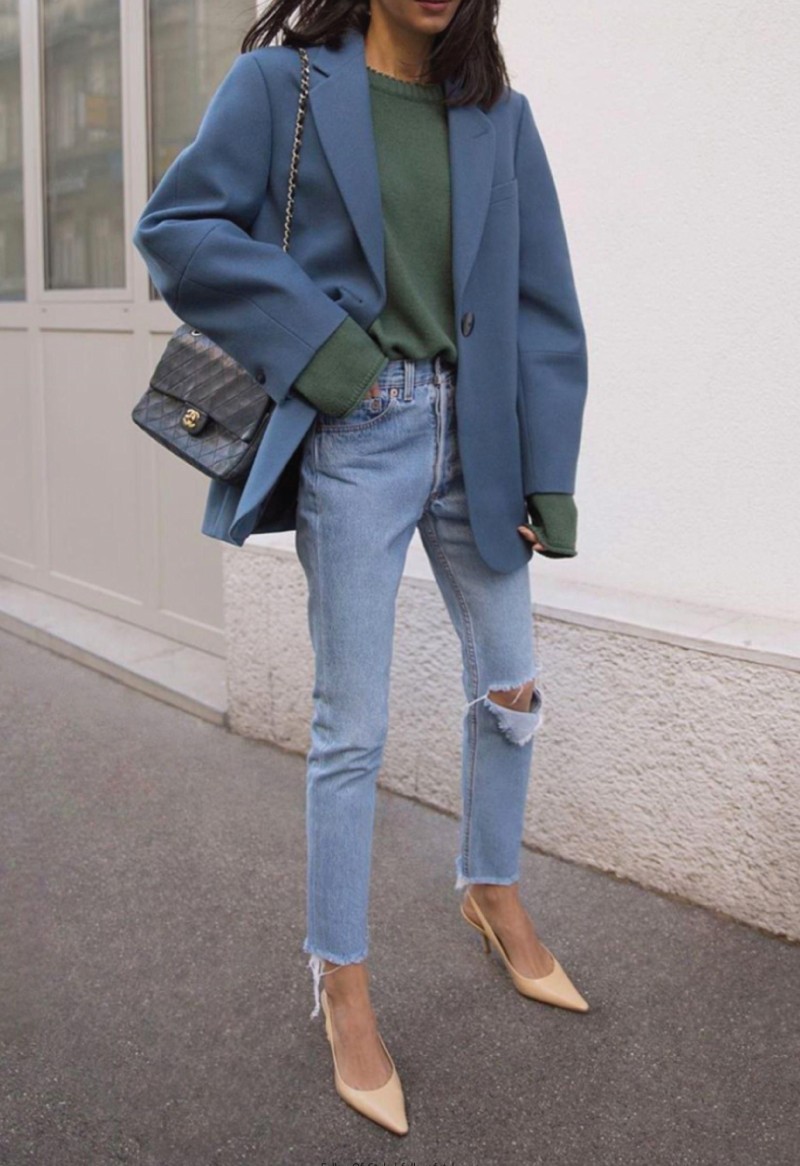 The Fall Trend Looks You Will Want To Show Off On Instagram. A blue oversized blazer with a green sweater underneath and denim jeans.