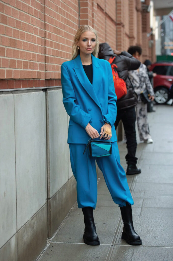 Colourful Suits To Elevate Your Street Style. Blue loose pant suit with black chunky boots.