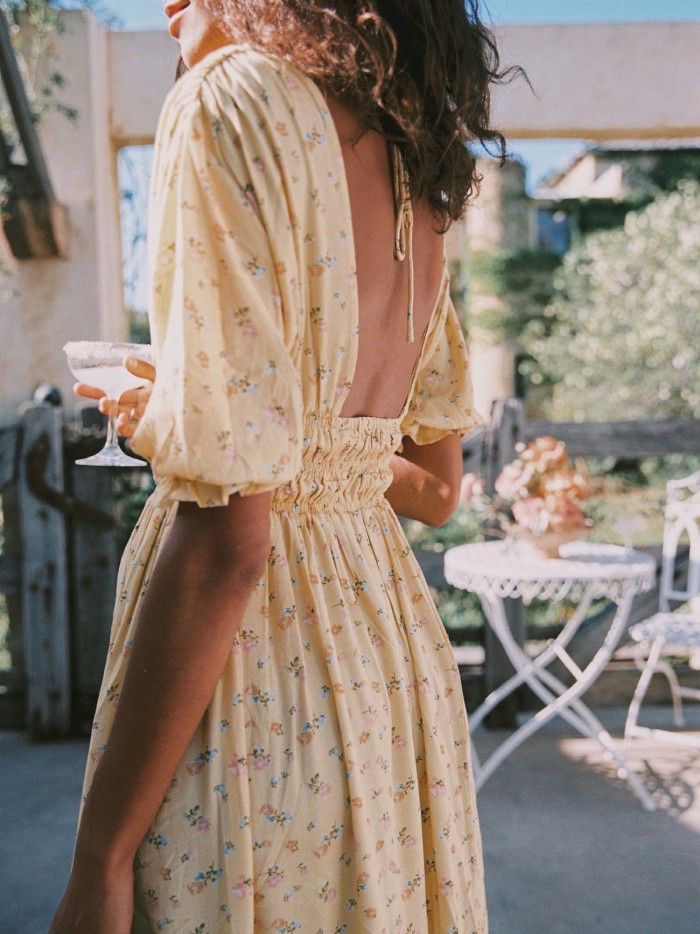 Dress Trends That French Women Are Bringing Back. Floral dress in yellow.