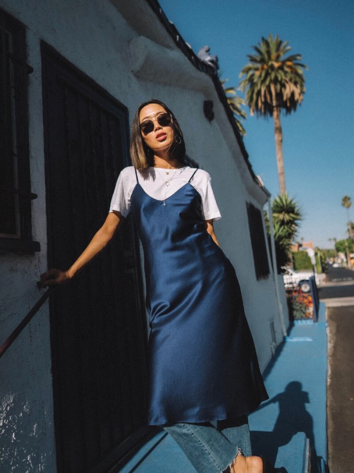 Dress Trends That French Women Are Bringing Back. Slip dress in blue with white shirt bellow.