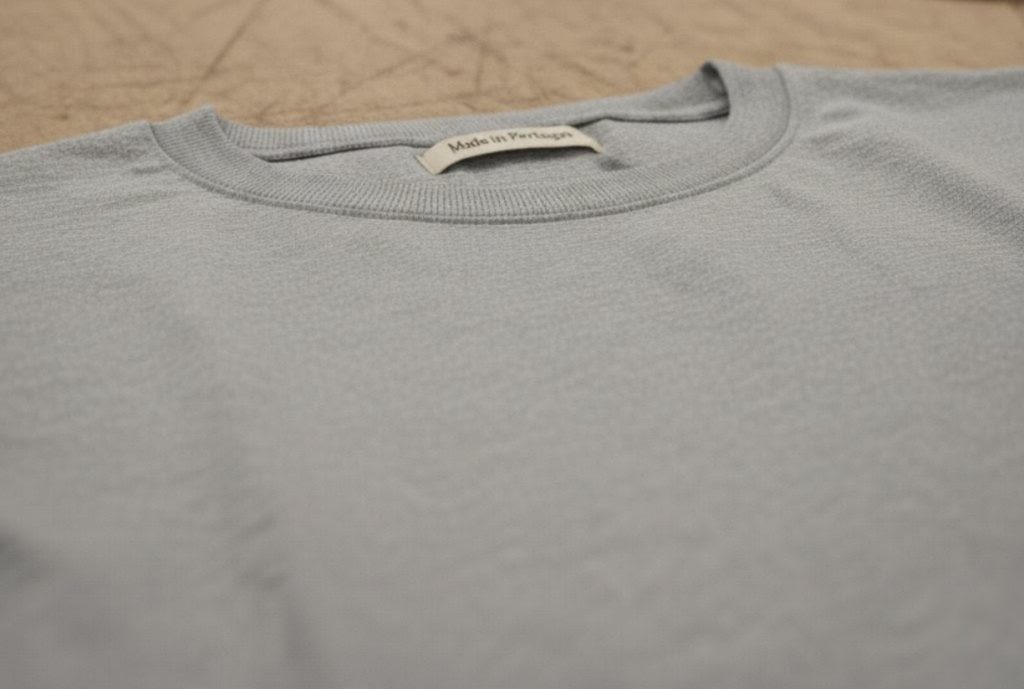 A premium grey t-shirt made with high-quality Portuguese fabric, highlighting the expert construction and "Made in Portugal" label.